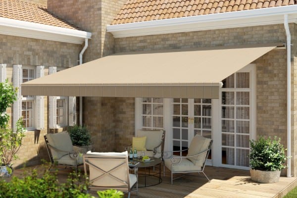 An outdoor coffee table under a brown awning